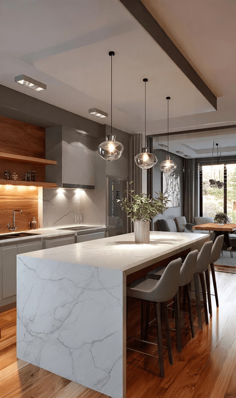 Marble waterfall island with wood cabinetry and pendant lighting